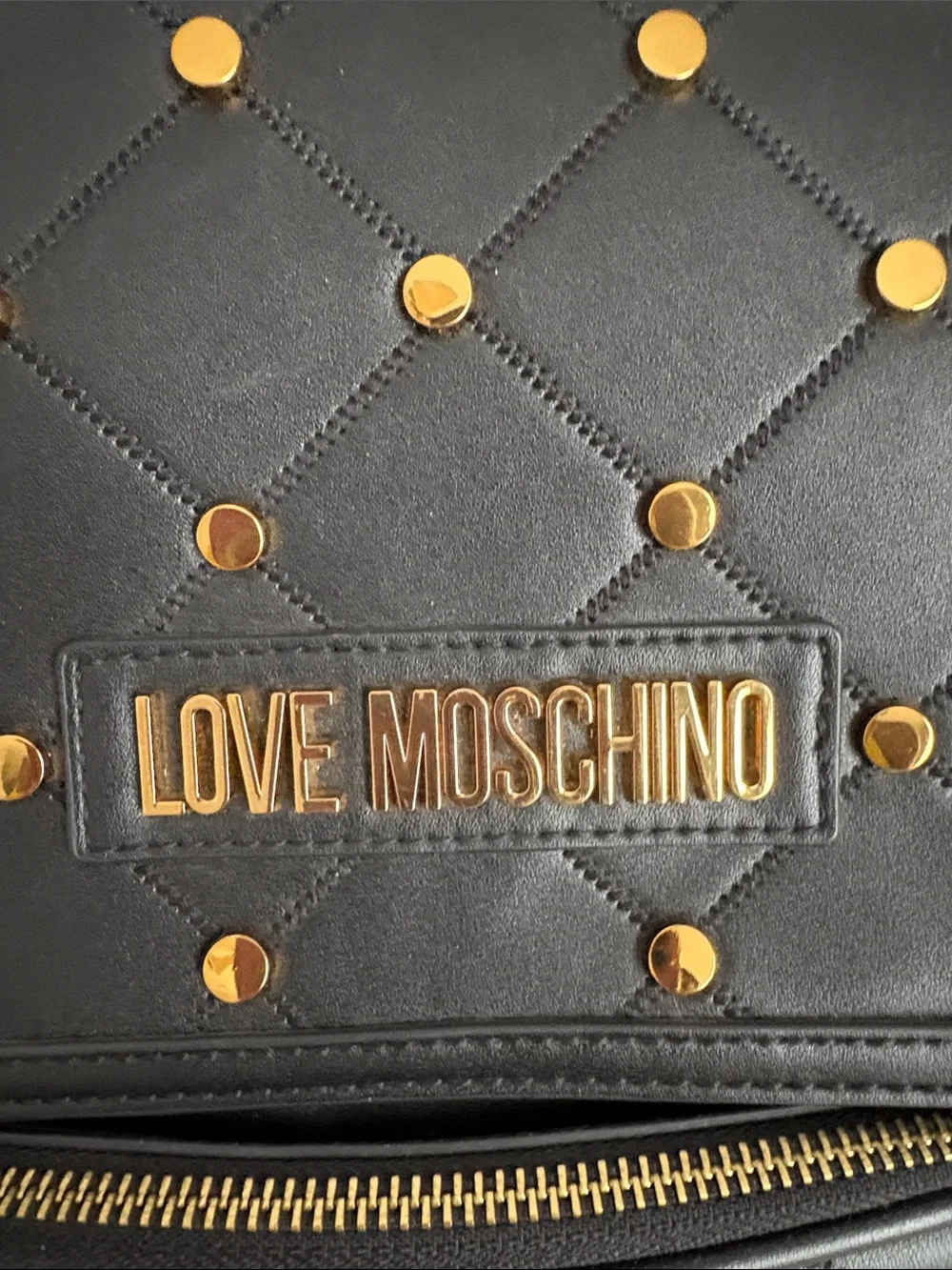BNWOT Designer LOVE MOSCHINO Backpack, Faux Leather, with gold metal design.